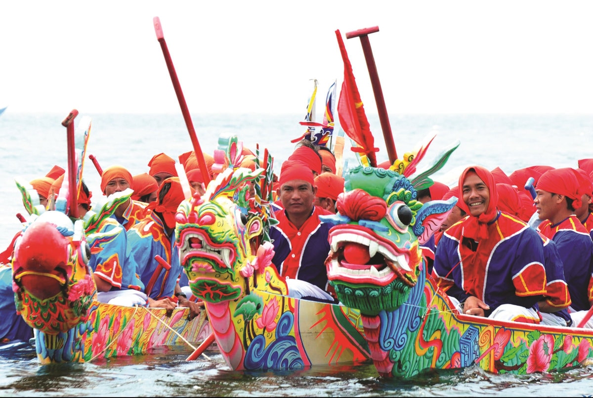 Long, colorful wooden boats glide through rivers and bays, powered by synchronized paddlers and cheering crowds lining the banks